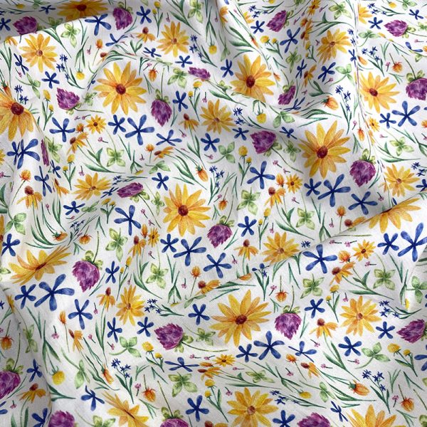 algodón estampado con flores silvestres en tonos amarillo y azul sobre fondo claro