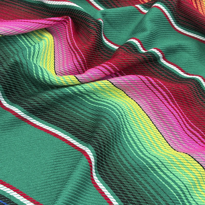 cambaya-saltillo-verde-800x800 Cambaya Saltillo Verde con fondo verde intenso y rayas multicolor de inspiración mexicana.